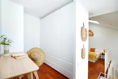 a dining room with a table and a couch at Querido Algarve Apartment in Faro
