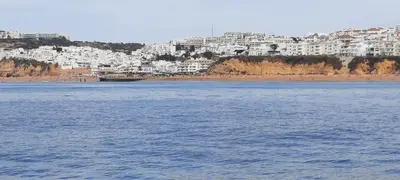 a large body of water with a city in the background at Casa Docim, casa tipica algarvia no centro da cidade velha in Albufeira