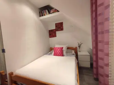 a small room with a bed in a attic at Casa Docim, casa tipica algarvia no centro da cidade velha in Albufeira