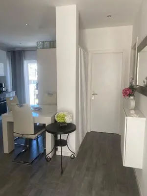 a living room with a table and a dining room at Casa Docim, casa tipica algarvia no centro da cidade velha in Albufeira