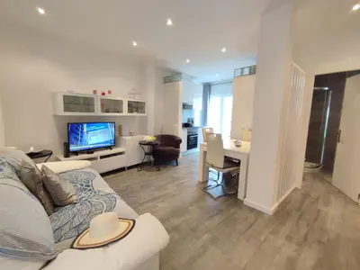 a living room with a couch and a television at Casa Docim, casa tipica algarvia no centro da cidade velha in Albufeira
