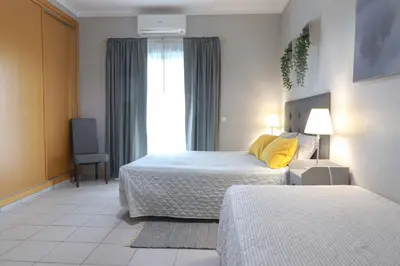 a hotel room with two beds and a couch at Agua Viva by Umbral in Albufeira