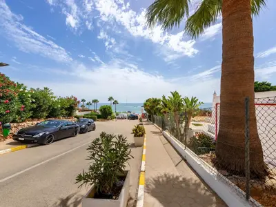 a street with a palm tree and cars on the road at Apartment Happy Moments by Interhome in Albufeira