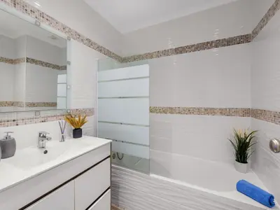 a bedroom with a large bed with blue towels on it at Apartment Happy Moments by Interhome in Albufeira