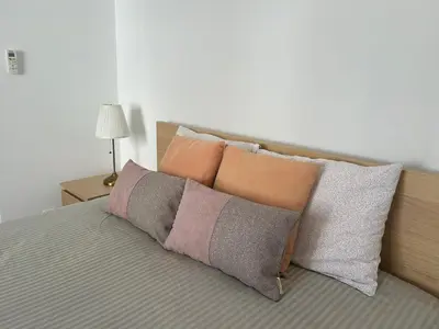 a group of pillows sitting on a bed with at Apartamento Batalha - Quarteira, Algarve, Portugal in Quarteira