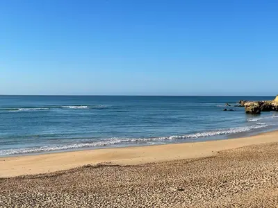 a sandy beach with the ocean in the background at Quinta do Lago 2-Bed Apartment - Golf Pool & Ac in Faro