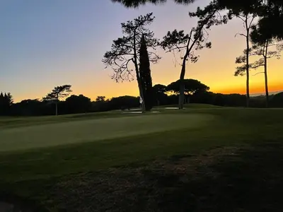 a sunset on a golf course with trees in the foreground at Quinta do Lago 2-Bed Apartment - Golf Pool & Ac in Faro
