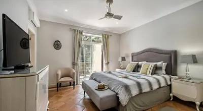 a bedroom with a large bed and a television at Quinta do Lago 2-Bed Apartment - Golf Pool & Ac in Faro
