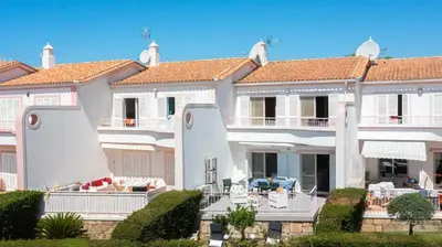 a large white house with balconies and landscaping at V3 Olhos dÁgua com piscina AC wifi 800m praia in Olhos de Água