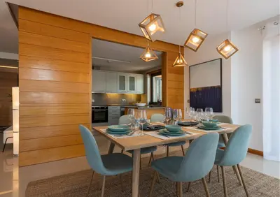 a dining room with a table and blue chairs at Algarve: Vale Lobo Golf&Beach with Private Pool II in Almancil