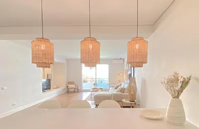 a living room with three chandeliers hanging from the ceiling at YES! Incrível Vista Piscina T2 HsR Vilamarina in Vilamoura