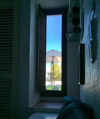 a window in a room with a view of an umbrella at Albufeira Home in Albufeira
