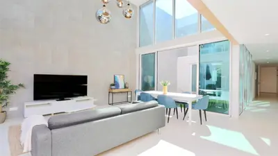 a living room with a couch and a dining room at Villa Miya - Clever Details, walking distance from the Marina, restaurants, bakeries and supermarkets,, free wifi, pool in Vilamoura