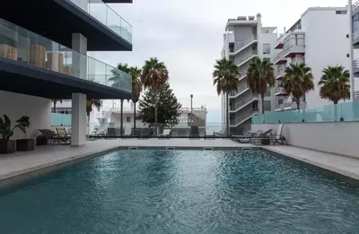a swimming pool in the middle of a building at Apartment Terracos do Mar - By Dalma Portuguesa in Quarteira