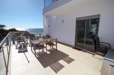 a balcony with a table and chairs and the ocean at Excellent Sea view 1 Bedroom Apartment, Verandas do Mar, Olhos de Agua AT05 in Olhos de Água