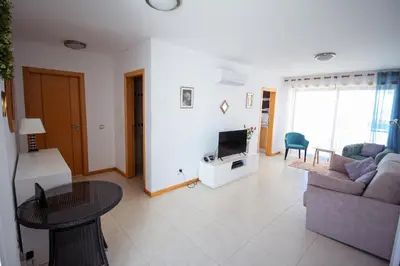 a living room with a couch and a tv at Excellent Sea view 1 Bedroom Apartment, Verandas do Mar, Olhos de Agua AT05 in Olhos de Água