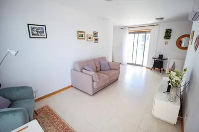 a living room with a couch and a table at Excellent Sea view 1 Bedroom Apartment, Verandas do Mar, Olhos de Agua AT05 in Olhos de Água