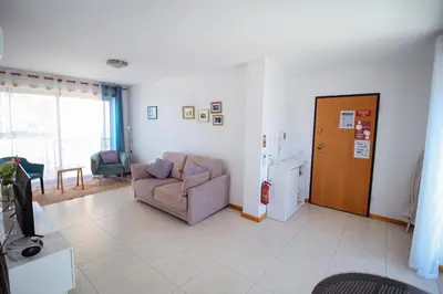 a living room with a chair and a couch at Excellent Sea view 1 Bedroom Apartment, Verandas do Mar, Olhos de Agua AT05 in Olhos de Água