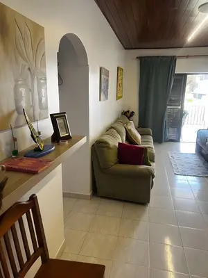 a living room with a couch and a table at Mouramar Vilamoura in Vilamoura