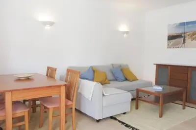 a living room with a couch and a table at Cosy flat, Salgados Village in Guia