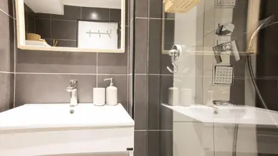 a bathroom with a sink and a shower at Loft Quinta da Balaia - Jacuzzi - By BEDZY in Albufeira