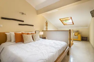 a living room with a couch and a skylight at Jardins da Falésia Family Duplex in Albufeira