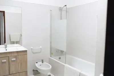 a bathroom with a toilet and a sink and a shower at Host Wise - Sweet & Sunny Flat - Ace Location in Quarteira