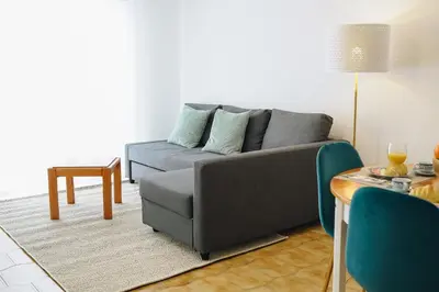 a living room with a couch and a table at Host Wise - Sweet & Sunny Flat - Ace Location in Quarteira