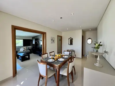 a dining room and living room with a table and chairs at Quarteira Classic 1 With Pool by Homing in Quarteira