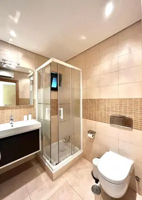 a bathroom with a shower and a toilet and a sink at Funtastic Villa With Pool in Albufeira