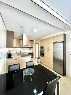 a kitchen with a black table and chairs in it at Funtastic Villa With Pool in Albufeira