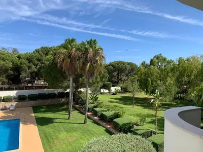an aerial view of a garden with palm trees and a swimming pool at Kasa Joly Albufeira By Calyferias in Albufeira