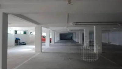 an empty parking garage with white walls and ceilings at Kasa Joly Albufeira By Calyferias in Albufeira