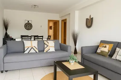 a living room with two couches and a table at Kasa Joly Albufeira By Calyferias in Albufeira