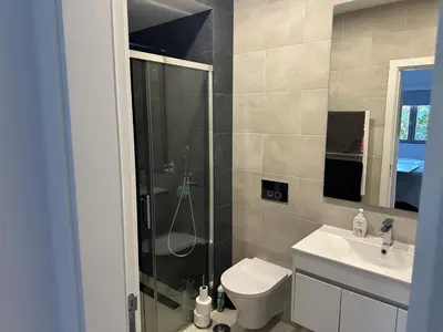 a bathroom with a shower and a toilet and a sink at Vila Golf in Vilamoura