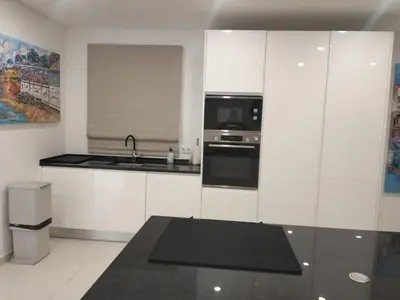 a white kitchen with a sink and a microwave at Vila Golf in Vilamoura