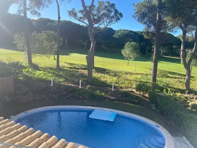 a swimming pool in a yard with trees at Vila Golf in Vilamoura