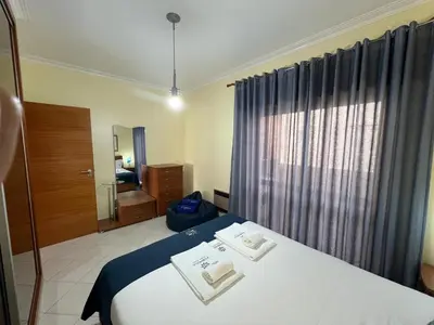 a hotel room with a bed with two towels on it at Infante Sagres by FHR1º linha da praia in Quarteira