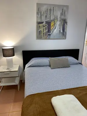 a bedroom with a bed and a painting on the wall at The Tiles House in Faro
