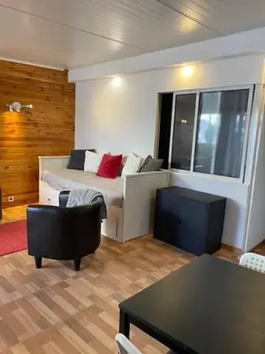 a room with a bed and a table and chairs at The Tiles House in Faro