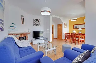a living room with blue couches and a tv at Villa Acoteias - By Dalma Portuguesa in Olhos de Água