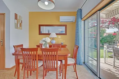 a dining room with a wooden table and chairs at Villa Acoteias - By Dalma Portuguesa in Olhos de Água
