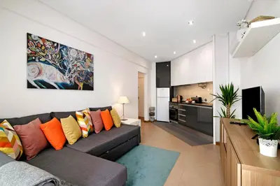 a living room with a couch and a tv at Apartamento Peron in Quarteira