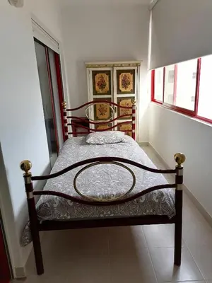 a small bedroom with a bed in a room at Leonel Barcelos in Quarteira