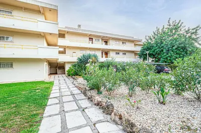 a building with a garden in front of it at BeGuest Copacabana Vilamoura Apartment in Quarteira