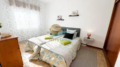 a bedroom with a bed and a window at Apartamentos Oura AreiaSol by Sunny Deluxe in Albufeira