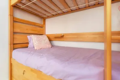 a bedroom with a bunk bed with purple sheets at Female Hostel in Faro
