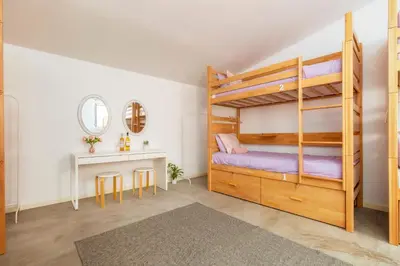 a bedroom with a bunk bed and a desk at Female Hostel in Faro