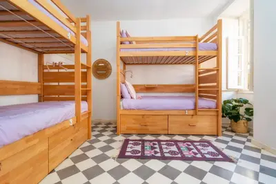 two bunk beds in a room with a checkered floor at Female Hostel in Faro