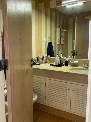 a bathroom with a sink and a mirror at House of Rising Sun in Quarteira